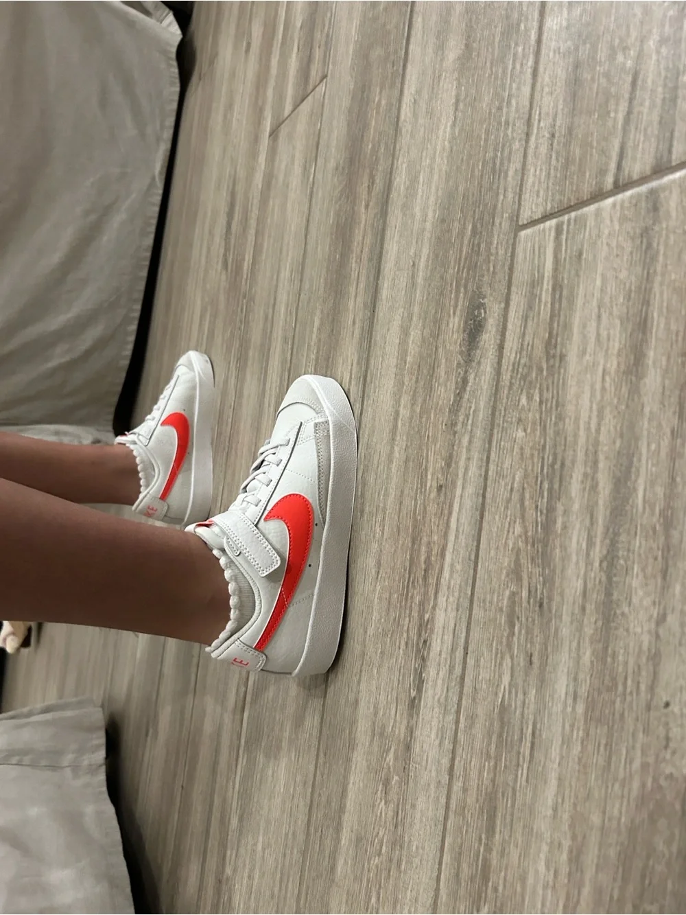 Nike Women’s White Sneakers with Coral Swoosh Accent